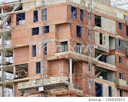 Incomplete Building Facade, Construction In Progress With Open Spaces And Unfinished Surfaces Evident 136638953