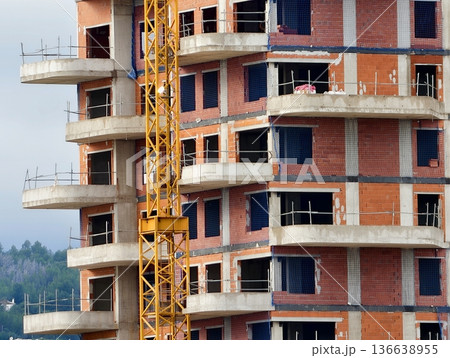 Urban Construction Scene, Developing Skyscraper Surrounded By Work Platforms And Urban Backdrop 136638955