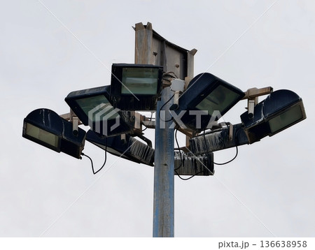 Industrial Lighting Details, Weathered Metal Fixtures Illuminate Infrastructure Under Cloudy Skies 136638958