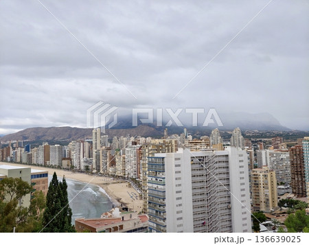 City Skyline View, Cityscape Along Water Displaying Mountain Silhouettes And Bustling Harbor Activity City Skyline View, Cityscape Along Water Displaying Mountain Silhouettes And Bustling Harbor Activity 136639025