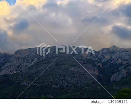 Dark Skies Create Dramatic Scene, Foreboding Valley Surrounded By Turbulent Weather And Rugged Terrain 136639132