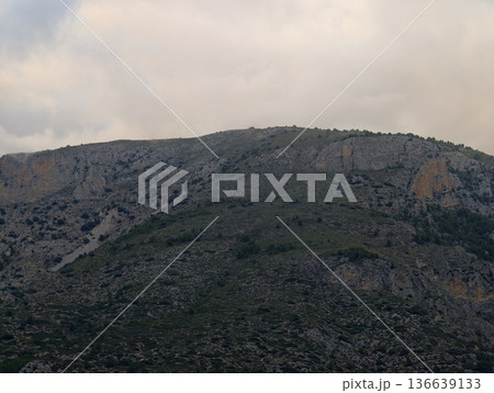 Calm Coastal Hill With Muted Colors, Gentle Elevated Landform Surrounded By Soft Colors And Distant Fog 136639133