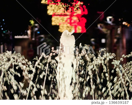Illuminated Splash Creates Vivid Display, Central Water Jet Shines With Surrounding Arched Flow Patterns Illuminated Splash Creates Vivid Display, Central Water Jet Shines With Surrounding Arched Flow Patterns 136639187