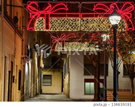 Luminous Narrow Alleyway Decorated Festively, Cozy Street With Glowing Lights And Holiday Ambiance Luminous Narrow Alleyway Decorated Festively, Cozy Street With Glowing Lights And Holiday Ambiance 136639191