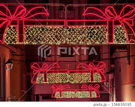 Contemporary Installation Featuring Luminous Gift Shape Adorned With Ribbon Patterns And Vivid Neon Lighting Contemporary Installation Featuring Luminous Gift Shape Adorned With Ribbon Patterns And Vivid Neon Lighting 136639195