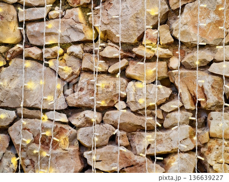 Textured Metallic Mesh And Earthy Stones Create Striking Urban Landscape Feature With Gold Accents 136639227