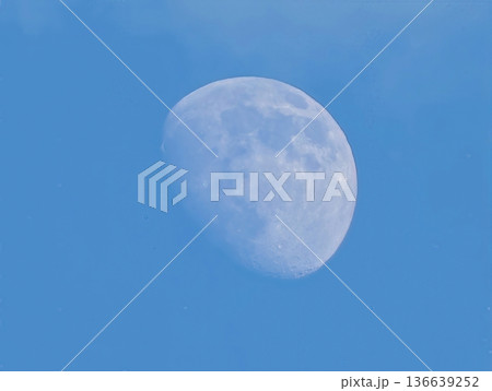 Bright Moon In Tranquil Daytime Sky, Peaceful Moonlit Scene In Clear Blue Sky Perfect For Travel Imagery 136639252