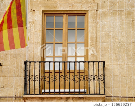 Historic Window Overlooking Festivities, Old Window With Decorative Iron Railings And Festive Atmosphere Historic Window Overlooking Festivities, Old Window With Decorative Iron Railings And Festive Atmosphere 136639257