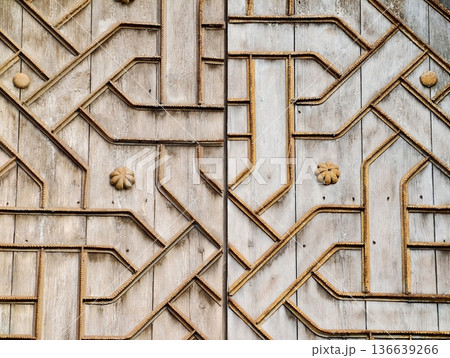 Decorative Carved Wooden Door, Detailed Carved Wooden Door Featuring Weathered Patina And Brass Studs Decorative Carved Wooden Door, Detailed Carved Wooden Door Featuring Weathered Patina And Brass Studs 136639266