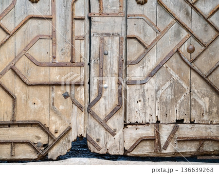 Antique Crafted Entrance With Age, Weathered Timber Door Showcasing Craftsmanship And Timeless Charm Antique Crafted Entrance With Age, Weathered Timber Door Showcasing Craftsmanship And Timeless Charm 136639268