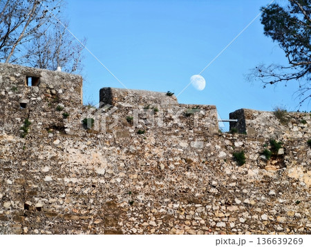 Moon Ascends Ancient Stone Ramparts, Soft Twilight Bathes Old Battlements Beneath Rising Lunar Glow Moon Ascends Ancient Stone Ramparts, Soft Twilight Bathes Old Battlements Beneath Rising Lunar Glow 136639269