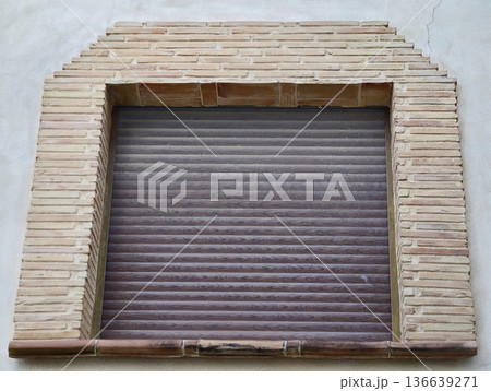 Industrial Storefront Appearance, Textured Metallic Shutter Combined With Rustic Brick Archway Industrial Storefront Appearance, Textured Metallic Shutter Combined With Rustic Brick Archway 136639271