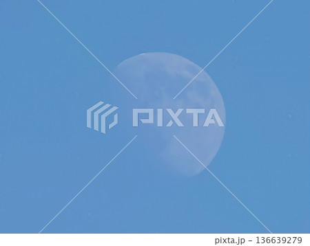 Tranquil Daytime Moon Casting Gentle Light Across Bright Azure Sky With Subtle Crater Markings Tranquil Daytime Moon Casting Gentle Light Across Bright Azure Sky With Subtle Crater Markings 136639279