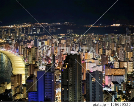 Luminous Boulevard Beside Crescent Bay Under Evening Sky With Lively Cityscape And Shimmering Water Luminous Boulevard Beside Crescent Bay Under Evening Sky With Lively Cityscape And Shimmering Water 136639520