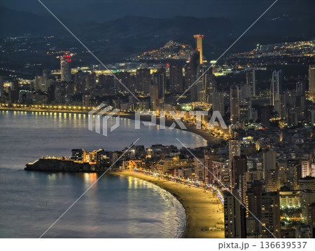 Sunny Shoreline With Lively Lights, Nighttime Coastal Walkway Illuminated With Vibrant Streetlights Sunny Shoreline With Lively Lights, Nighttime Coastal Walkway Illuminated With Vibrant Streetlights 136639537
