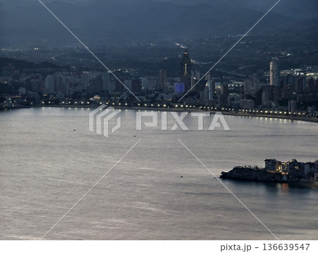 Evening Cityscape Scene, Tranquil Nighttime View Capturing Bustling City Seafront Under Moody Sky 136639547