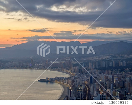 Editorial Photograph Depicting Turbulent Sunset Over Shoreline With Dramatic Cloud Patterns 136639553