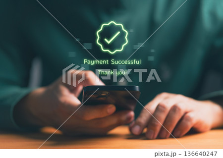 Person holding smartphone with digital confirmation message Payment Successful, representing online transaction, mobile banking, e-commerce payment, fintech technology, and secure financial service. 136640247