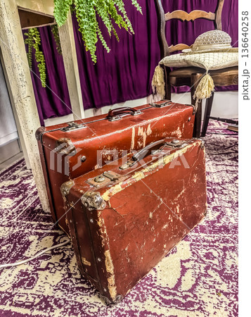 The romance of travel. This close-up captures the rich texture and history of two weathered vintage suitcases, evoking nostalgia and a sense of adventure.. High quality photo The romance of travel. This close-up captures the rich texture and history of two weathered vintage suitcases, evoking nostalgia and a sense of adventure.. High quality photo 136640258