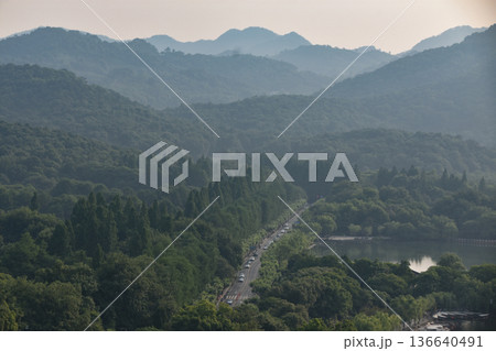 A road going through forested mountains outside Hangzhou in China A road going through forested mountains outside Hangzhou in China 136640491