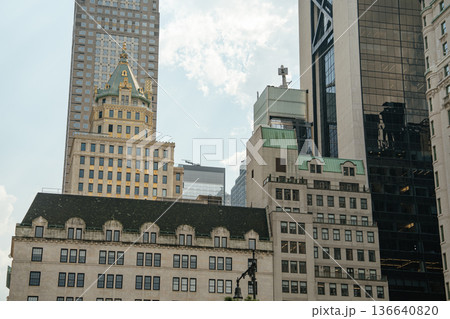 A beautiful contrast of architectural styles in Midtown Manhattan. Ornate historic facades meet sleek glass skyscrapers under a bright summer sky. 136640820