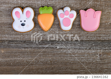 Gingerbread Easter cookies with colorful icing on wooden table. 136641162