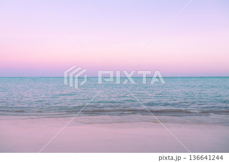 Tropical sunset with pink cloudy sky and peaceful water. 136641244