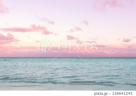 Tropical sunset with pink cloudy sky and peaceful water. 136641245