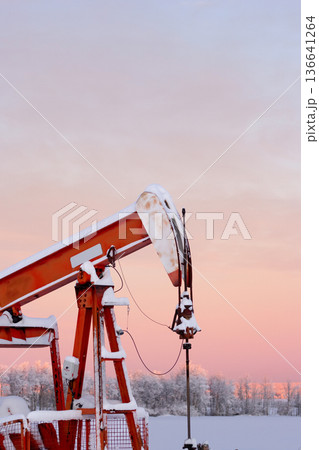 Snow Covered Oil Pumpjack at Winter Sunrise Snow Covered Oil Pumpjack at Winter Sunrise 136641264