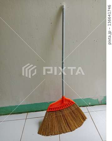 Broom on the floor in the house. House cleaning concept Broom on the floor in the house. House cleaning concept 136641746
