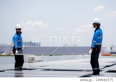 Caucasian worker team installing solar cell for sustainable energy power. Caucasian worker team installing solar cell for sustainable energy power. 136642575