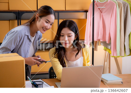 Two asian woman working in small business online store, online seller. Two asian woman working in small business online store, online seller. 136642607
