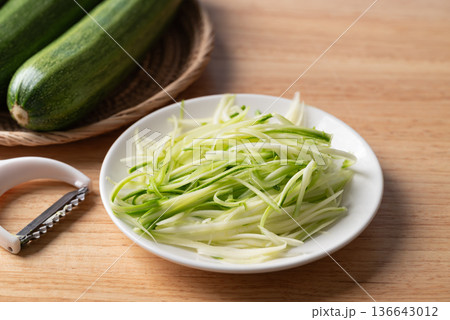 Fresh zucchini noodles (zoodles) in a white plate, prepared for healthy cooking 136643012