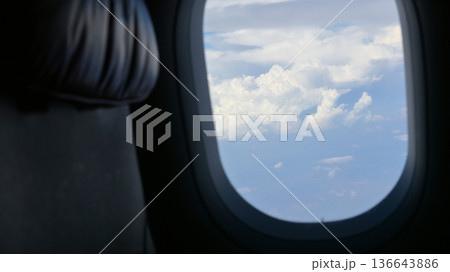 Scenery outside the window of a passenger plane, beautiful blue sky and white cloud view Scenery outside the window of a passenger plane, beautiful blue sky and white cloud view 136643886