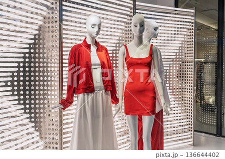 Fashionable Mannequins Showcasing Trendy Apparel in an Upscale Retail Shop Display Fashionable Mannequins Showcasing Trendy Apparel in an Upscale Retail Shop Display 136644402