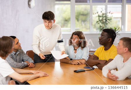 Group of men discussing something at the desk 136644515