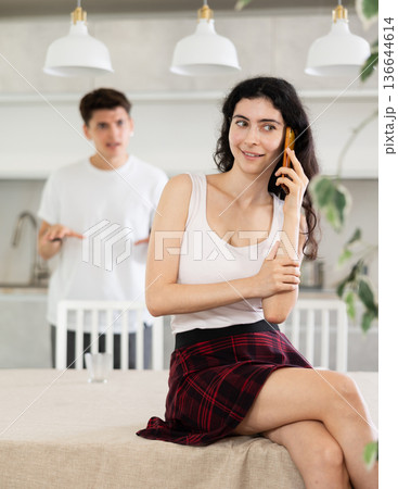 Girl is chatting on phone and ignores her husbands screams 136644614