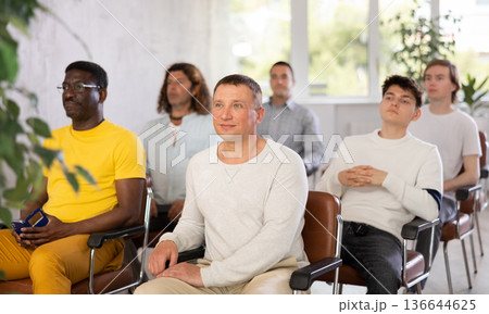 Group of men listening to lecture in auditorium attentively 136644625