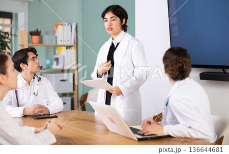 Young female doctor leading medical meeting in office Young female doctor leading medical meeting in office 136644681