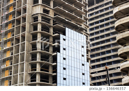 Concrete tower under development. Industrial building featuring scaffolding and raw surfaces 136646357