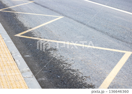 Detailed capture of textured paving stones and shiny asphalt edge during peaceful city dawn Detailed capture of textured paving stones and shiny asphalt edge during peaceful city dawn 136646360
