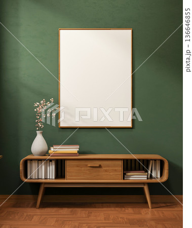 White frame on dark green wall over flower vase and book on drawer table on wooden tiles floor room. White frame on dark green wall over flower vase and book on drawer table on wooden tiles floor room. 136646855
