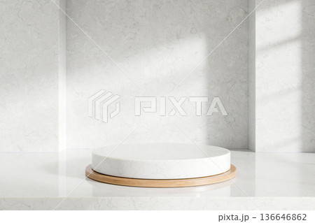 Empty round display platform over wooden tray on white marble counter and sunlight shining on a wall 136646862