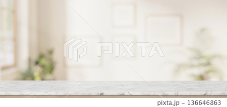 Empty marble tabletop across blank frame on white wall in a living room with sunlight through window 136646863