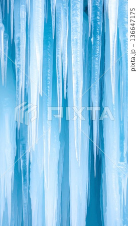 Frozen Icicles Hanging with Blue Tint and Clear Texture in a Cold Winter Day 136647175