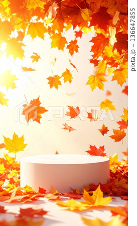 Vibrant Autumn Leaves Falling around White Cylindrical Display Podium for Product Showcase 136647855