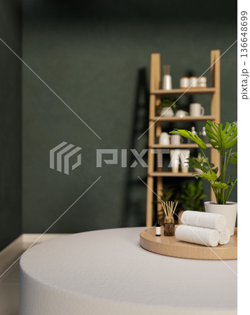 Towel and diffuser with essential oil on tray over table across wooden shelf in dark green wall room Towel and diffuser with essential oil on tray over table across wooden shelf in dark green wall room 136648699