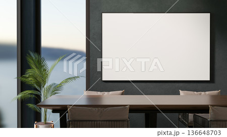 White frame or monitor screen on wall aside window and wooden table with chairs in living room or office. 136648703