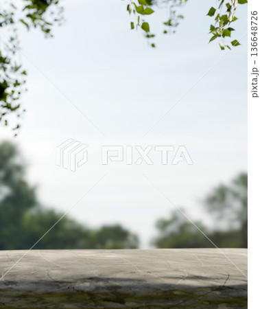 Empty blank stone table or rock surface platform with green leaves branches and blue sky in a forest Empty blank stone table or rock surface platform with green leaves branches and blue sky in a forest 136648726