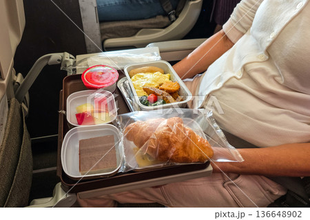 SImple airline flight meal served on serving tray of economy class sector SImple airline flight meal served on serving tray of economy class sector 136648902